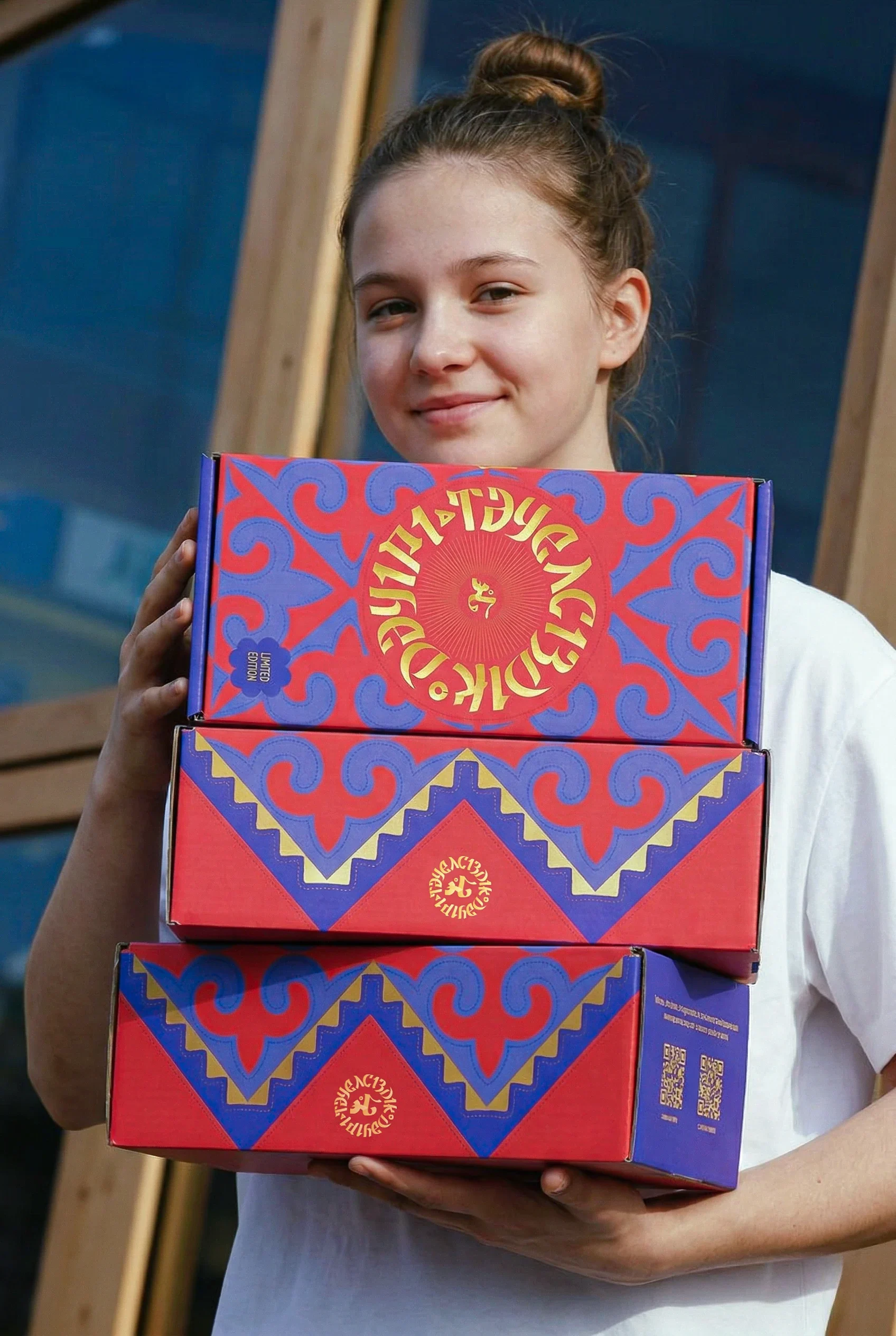 Girl holding three Era of Independence game boxes